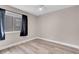Bright bedroom featuring wood floors, modern ceiling fan, and a window allowing natural light at 42 Megan Dr, Henderson, NV 89074