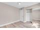 This bedroom is complete with wood floors, a ceiling fan and a closet with mirrored doors at 42 Megan Dr, Henderson, NV 89074