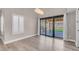 Open-concept dining area with sliding glass doors to the backyard and modern light fixture at 42 Megan Dr, Henderson, NV 89074