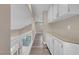 Bright hallway with ample storage and white railings, showcasing a clean and open design at 42 Megan Dr, Henderson, NV 89074