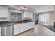 Kitchen with stainless steel dishwasher, updated countertops, and a view of the backyard and dining area at 42 Megan Dr, Henderson, NV 89074