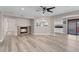 Open-concept living area with a fireplace, neutral color palette, and access to the backyard at 42 Megan Dr, Henderson, NV 89074