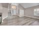 Spacious living room features wood flooring, fireplace, and abundant natural light from large windows at 42 Megan Dr, Henderson, NV 89074