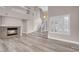 Bright and airy living room with a fireplace, staircase, and large windows with plantation shutters at 42 Megan Dr, Henderson, NV 89074