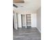 This bedroom features a closet with sliding doors and modern gray wood-look floors at 4536 Payson Ave, Las Vegas, NV 89115