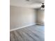 This is a simple bedroom with gray wood-look floors and a ceiling fan at 4536 Payson Ave, Las Vegas, NV 89115