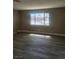A naturally lit room with wood-style flooring and an exterior view at 4536 Payson Ave, Las Vegas, NV 89115