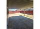 Covered patio in a backyard with a red wooden fence at 4536 Payson Ave, Las Vegas, NV 89115