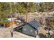 Overhead view of a home, nestled in trees, and featuring a fenced outdoor area at 4578 Yellow Pine Ave, Mount Charleston, NV 89124