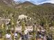 Aerial view of charming mountain home surrounded by mature trees and stunning views at 4578 Yellow Pine Ave, Mount Charleston, NV 89124