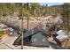 Aerial view of the home nestled among lush trees and a quaint mountain neighborhood at 4578 Yellow Pine Ave, Mount Charleston, NV 89124