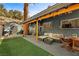 Outdoor deck area with seating, artificial turf, and string lights perfect for backyard gatherings at 4578 Yellow Pine Ave, Mount Charleston, NV 89124