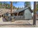 Charming home featuring distinctive architecture, a fenced yard, and mature trees, offering a serene and inviting atmosphere at 4578 Yellow Pine Ave, Mount Charleston, NV 89124