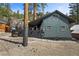 Charming grey home with a dark metal roof and a fenced yard, with wooded views at 4578 Yellow Pine Ave, Mount Charleston, NV 89124