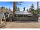 Home exterior with a dark fence and gravel landscaping at 4578 Yellow Pine Ave, Mount Charleston, NV 89124
