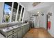 A kitchen with green cabinets, granite countertops, stainless steel appliances, and hard wood flooring at 4578 Yellow Pine Ave, Mount Charleston, NV 89124