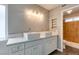 Bathroom with double sink vanity, quartz countertop, and stall shower with wood accent wall at 4731 Torrence Dr, Las Vegas, NV 89103