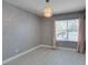 Bedroom showcasing a modern chandelier and ample natural light from the window at 4731 Torrence Dr, Las Vegas, NV 89103