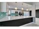 Modern kitchen featuring quartz countertops, stainless steel appliances and designer lighting at 4731 Torrence Dr, Las Vegas, NV 89103