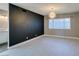An open living room features a black accent wall and a modern light fixture at 4731 Torrence Dr, Las Vegas, NV 89103