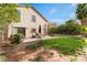 Spacious backyard featuring lush green lawn, patio seating, and mature landscaping at 4817 Friar Ln, Las Vegas, NV 89130