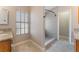 Bright bathroom featuring a granite countertop, window, and walk-in shower with grey tiling at 4817 Friar Ln, Las Vegas, NV 89130