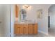 Ensuite bathroom featuring a granite countertop, wood cabinets, and updated lighting at 4817 Friar Ln, Las Vegas, NV 89130