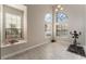 Bright bonus room featuring large windows, tile flooring, and an exercise bike at 4817 Friar Ln, Las Vegas, NV 89130