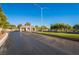Gated community entrance with manicured landscaping and a secure entry point at 4817 Friar Ln, Las Vegas, NV 89130