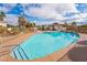 Sparkling community pool with lounge chairs and well-maintained landscaping at 4817 Friar Ln, Las Vegas, NV 89130