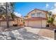 Charming two-story home with stucco siding, desert landscaping, and a two-car garage at 4817 Friar Ln, Las Vegas, NV 89130
