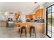 Open kitchen with granite counters, wooden cabinets, and access to backyard area at 4817 Friar Ln, Las Vegas, NV 89130
