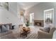 Cozy living room with a fireplace, large windows, and stylish furniture at 4817 Friar Ln, Las Vegas, NV 89130