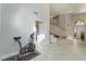 Open-concept living area with tall ceilings, tile flooring, and a staircase to the second level at 4817 Friar Ln, Las Vegas, NV 89130