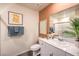 Well-lit bathroom with a vanity, toilet, framed art and decorative towels at 4828 Lilac Ridge Ave # 26, Las Vegas, NV 89141