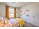 A bright bedroom features natural light from a large window with sunny yellow drapes at 4828 Lilac Ridge Ave # 26, Las Vegas, NV 89141