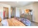 Bright bedroom with access to walk-in closet; dresser with large mirror and colorful comforter at 4828 Lilac Ridge Ave # 26, Las Vegas, NV 89141