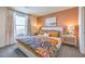 Bright bedroom features a comfortable bed, stylish furnishings, and a window providing natural light at 4828 Lilac Ridge Ave # 26, Las Vegas, NV 89141