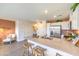 Bright kitchen with a stainless steel refrigerator, a quartz island, and a cozy chair with a lamp in the background at 4828 Lilac Ridge Ave # 26, Las Vegas, NV 89141