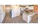 Spacious kitchen featuring modern island with barstool seating, stainless appliances, and pantry at 4828 Lilac Ridge Ave # 26, Las Vegas, NV 89141