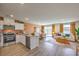 Open-concept kitchen with stainless appliances, quartz countertops, and a seamless flow to the living area at 4828 Lilac Ridge Ave # 26, Las Vegas, NV 89141