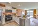 Modern kitchen with stainless steel appliances, stylish countertops, and an open layout to the dining and living spaces at 4828 Lilac Ridge Ave # 26, Las Vegas, NV 89141