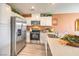Well-lit kitchen featuring stainless steel appliances, quartz countertops, and views into an open floorplan at 4828 Lilac Ridge Ave # 26, Las Vegas, NV 89141
