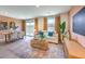 Open-concept living area boasts natural light, modern furnishings, and a dining area at 4828 Lilac Ridge Ave # 26, Las Vegas, NV 89141