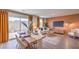 Open-concept living and dining area features hardwood floors and a sliding glass door to the backyard at 4828 Lilac Ridge Ave # 26, Las Vegas, NV 89141