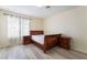 This bedroom features wood floors, a sleek sleigh bed, and matching wood nightstands at 4869 S Torrey Pines Dr # 101, Las Vegas, NV 89103