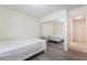 This bedroom features gray wood floors, and large mirrored closet doors for added light at 4869 S Torrey Pines Dr # 101, Las Vegas, NV 89103