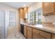 Efficient kitchen featuring light cabinets, white appliances, and tiled countertops at 4869 S Torrey Pines Dr # 101, Las Vegas, NV 89103