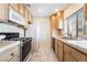 Efficient kitchen featuring light cabinets, white appliances, and tiled countertops at 4869 S Torrey Pines Dr # 101, Las Vegas, NV 89103