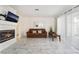 Bright living room with a tiled fireplace, light marble floors, and sheer curtains at 4869 S Torrey Pines Dr # 101, Las Vegas, NV 89103